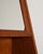 Teak wall-mounted cabinet with an opening mirror door, internal storage, and a double shelf. Scandinavian design, 1960s....