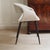 The chair is a newly produced piece of seating furniture with a fully upholstered shell body and an open cutout in the...