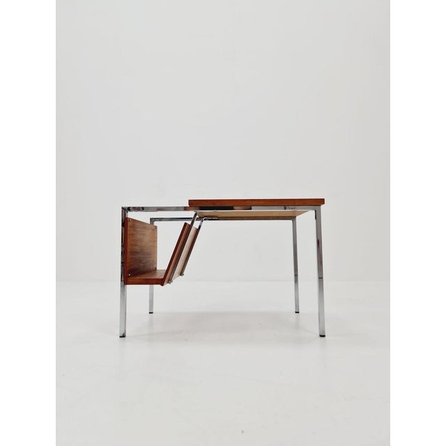 Danish Mid century teak side table with magazine rack, 1960s Dimensions: 40 D x 60 W x 40 H cm The magazine rack is...