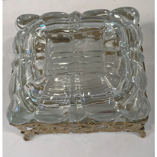 Nice vintage Hollywood Regency glass lidded box with a gold metal frame. It was originally used for powder but could be...