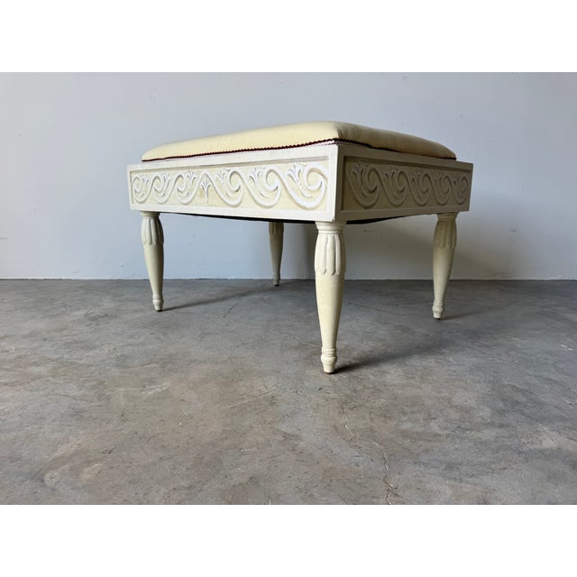 Elevate your space with this charming Vintage Louis XVI Style Cream Ottoman, featuring beautifully carved wooden details...