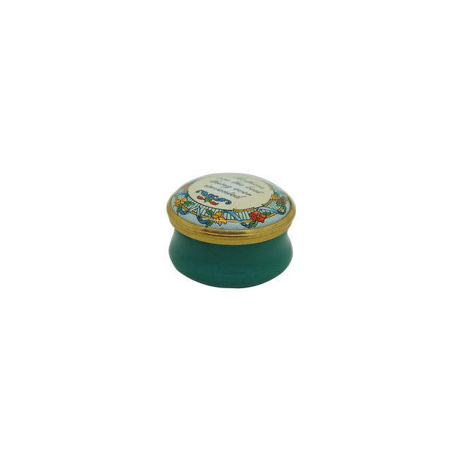 Vintage round, gold-trimmed enamel trinket box by Halcyon Days Enamels, featuring a cream-colored lid with a decorative...