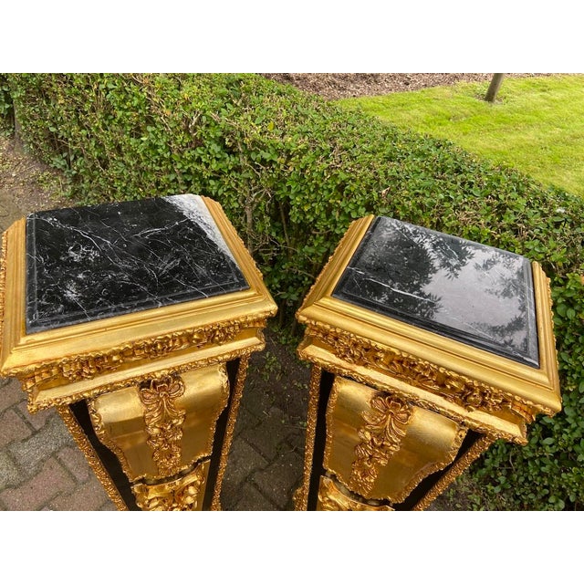 A sophisticated pair of 1980 French Louis XVI–style pedestals, handcrafted in solid beechwood with a striking black and...