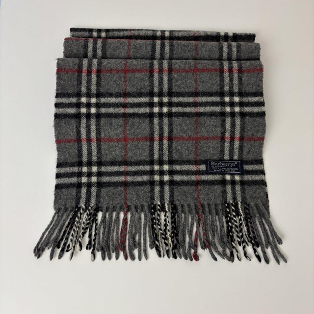 Burberry Grey Classic 100% Lambswool Scarf. Vintage Burberrys of London check in grey with black, white and red stripes,...