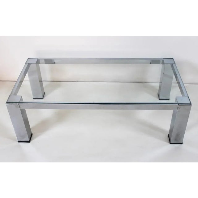 Elegant rectangular Coffee Table with steel structure and glass top. Dimensions: L110xD55xH33 cm. Period: 80s Origin: Italy