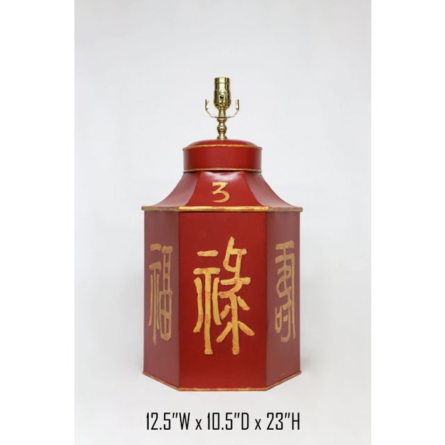 This vintage tea caddy lamp is constructed out of tole and is painted with old style chinese characters representing...