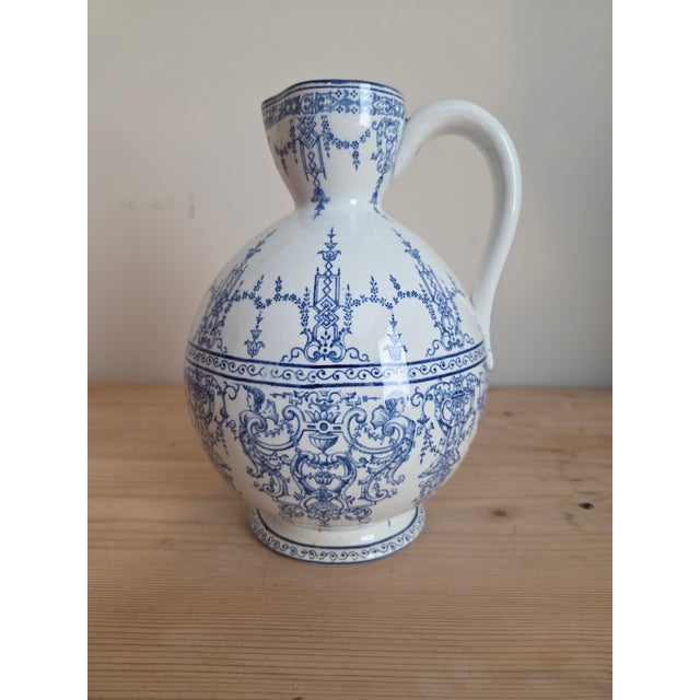 The Gien mark on the base tells you what you're holding — a pitcher from one of France's oldest and most respected faïence...