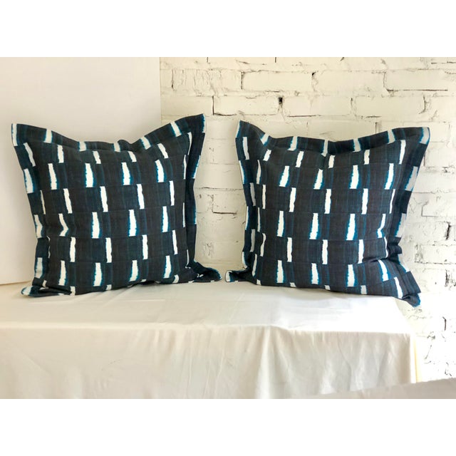 Pair of 24" square flange edge linen pillows dyed indigo blue on white in a geometric stripe. The pillows have a hidden...