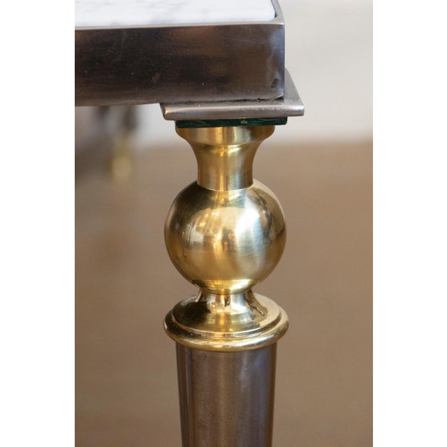 This sophisticated 20th-century French coffee table is a striking example of modernist elegance combined with classical...