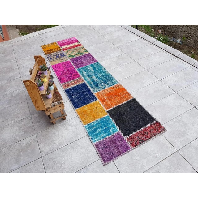 This is a vintage Turkish Oushak rug from the Mid 20th Century. The piece was hand-knotted.