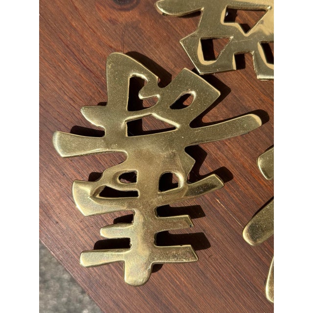 Set of three vintage brass Chinese characters that can be used as either wall decor or trivets. It is my understanding...