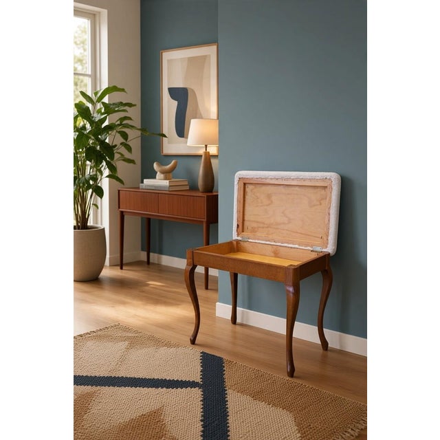 Elegant piano stool in stained birch with softly curved legs and a newly upholstered seat in Poodle in the color Cream...