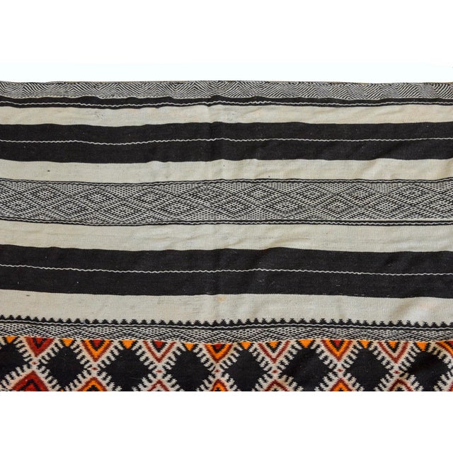 A wonderful mid-20th century Moroccan kilim runner with alternating multi-colored stripes all woven with geometric pattered.