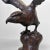 This Japanese cast-iron sculpture depicts a powerful eagle poised to take flight. with its wings spread wide and a...