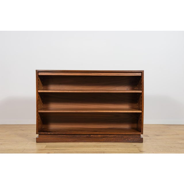 This bookcase was manufactured in Denmark during the 1930s and is designed in the Art Deco style. The piece is...
