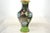 Tall intricate cloisonne vase with large aqua, magenta and green flowers accented by tight gold encrusted spirals over a...