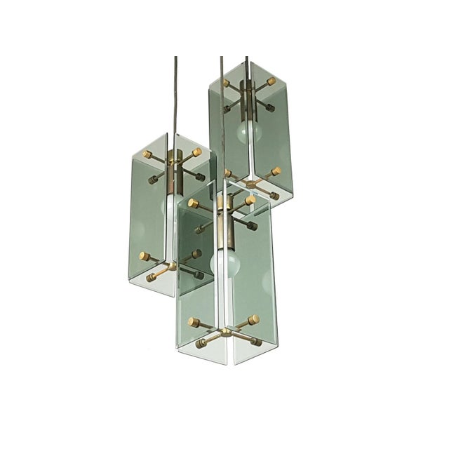This elegant lamp was produced in Italy around the 1960s. It is composed by 3-lights pendants at different adjustable...