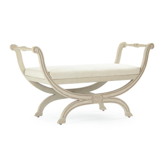 The Beatrice Bench from Zentique is a French country upholstered bench with an off-white linen padded seat on a distressed...