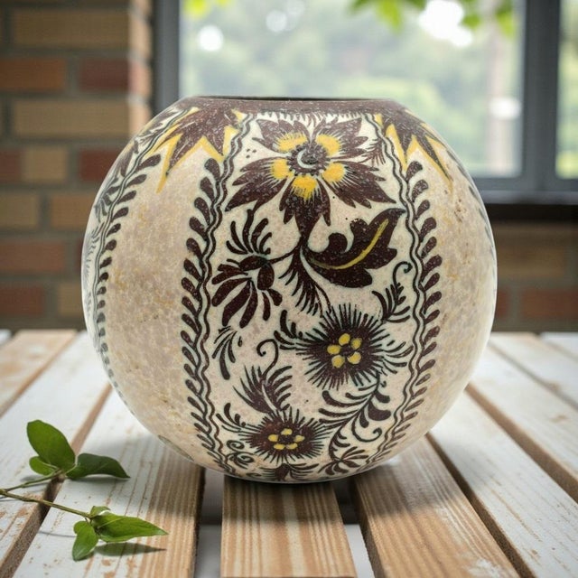 A hand-painted Dutch art pottery vase produced by Koninklijke Plateelbakkerij Zuid-Holland in Gouda. The rounded cabinet...