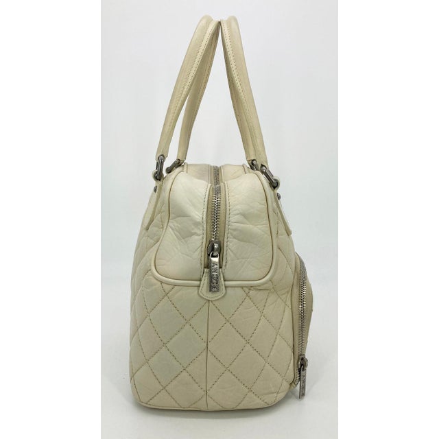 Chanel Paris New York Cream Distressed Bowling Tote in very good condition. Clean corners and edges. one stain inside on...