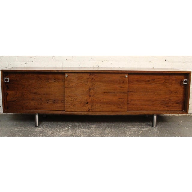 This Danish rosewood side board was designed by Bodil Kjaer in 1959. This piece was made by E. Pedersen & Søn in Denmark....