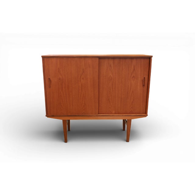 Danish neat cabinet in teak with sliding doors. The cabinet is in a very unusual neat size that is nevertheless just as...