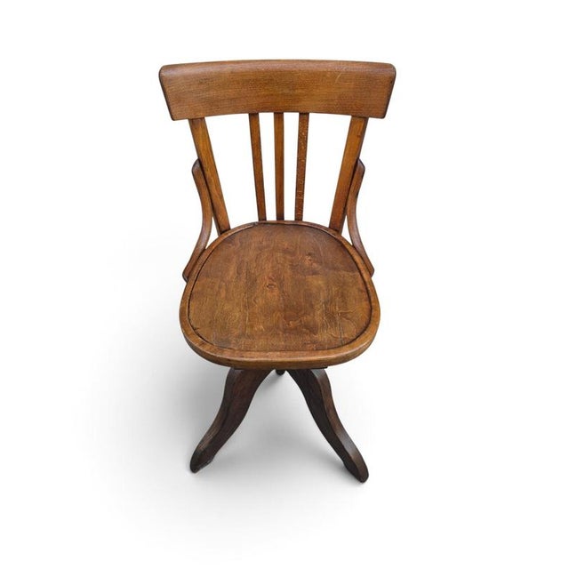 A handsome and unusual 19th-century ship’s swivel chair, crafted from solid oak and featuring an ingenious height-...