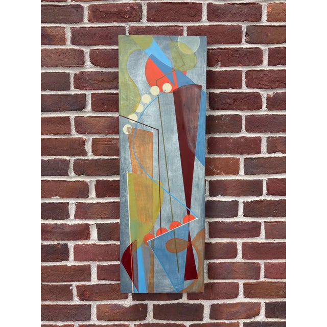 The artwork presents an abstract composition characterized by geometric forms and a vibrant interplay of colors, including...
