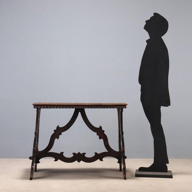 This small walnut refectory table, dating back to the early 20th century, features distinctive features that make it a...