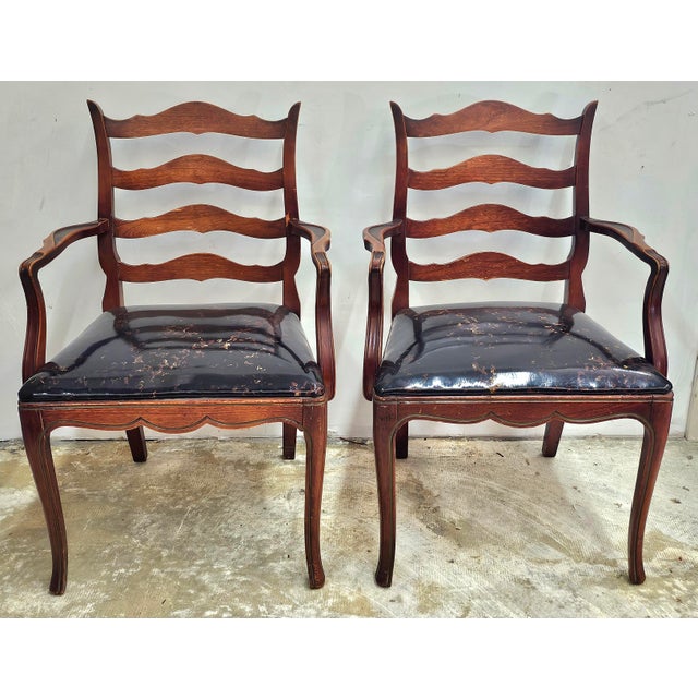 A Mid 20th Century Pair of French Country Mahogany and Vinyl Upholstered Ladderback Armchairs from Woodward and Lothrop...