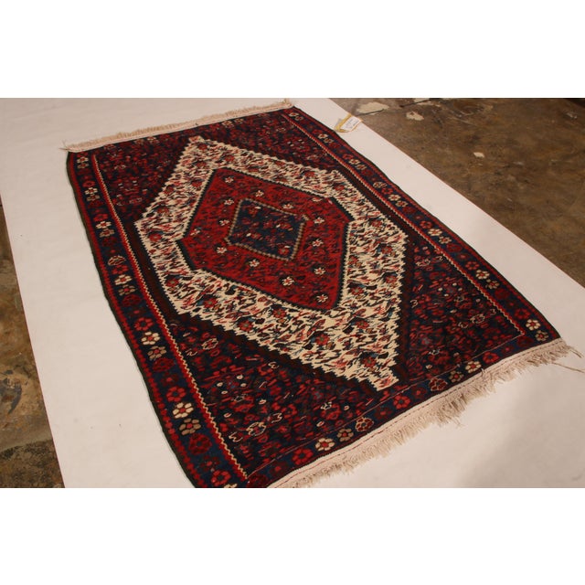 Mid Century and vintage Senneh originating circa 1950-1960, this 3’ x 5’ Persian Kilim rug was created in a traditional...