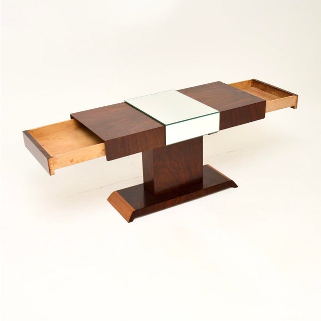 A stylish and unusual Art Deco figured walnut mirrored coffee table. This was made in England, it dates from the 1930’s....