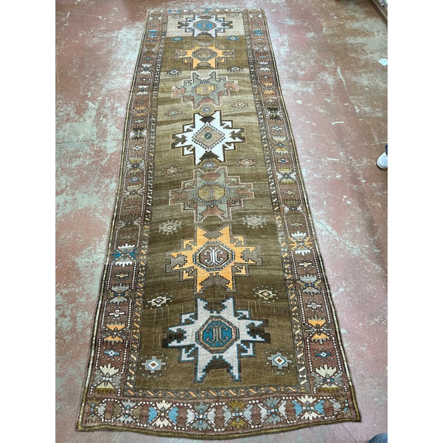Vintage Turkish runner, hand-knotted in Turkey from 100% wool. Measuring 4’10” x 14’10”, the rug features a traditional...