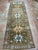 Vintage Turkish runner, hand-knotted in Turkey from 100% wool. Measuring 4’10” x 14’10”, the rug features a traditional...