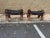 Pair of Vintage Camel Saddle Stools 20th Century, with black vinyl upholstered seat cushion, the base with brass inlaid in...