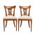 Pair of French Neoclassic upholstered seat side chairs. The chairs are defined by sabre front and raked rear legs which...