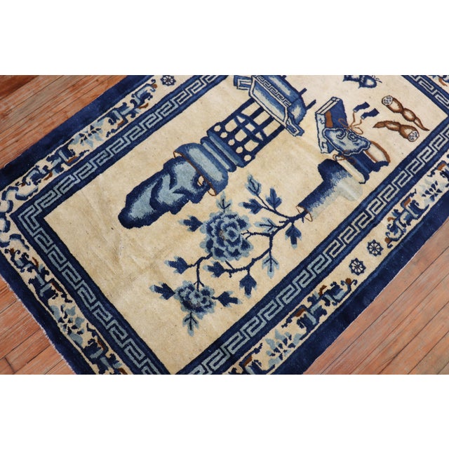 An early 20th century Chinese Peking carpet in tan and blue colors featuring a whimsical motif. Even Full Pile Condition...