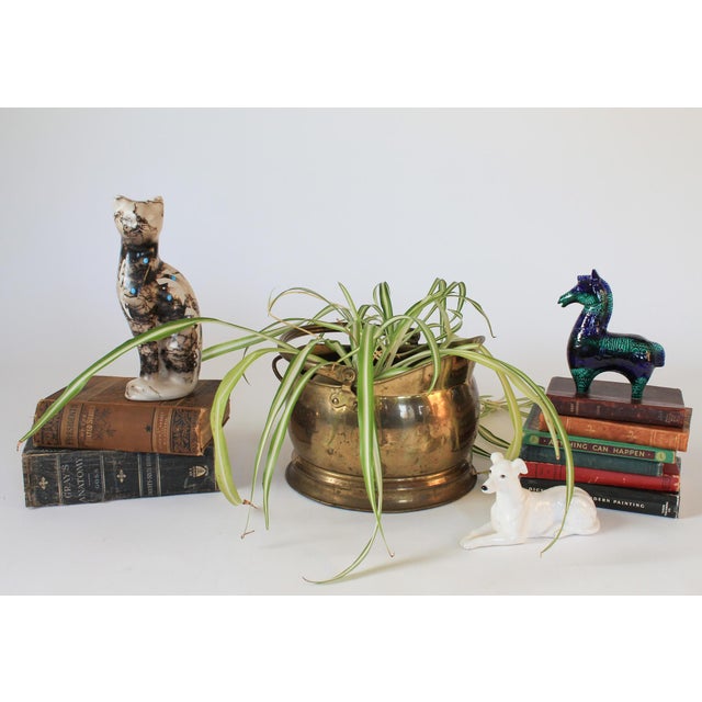 Vintage English brass fireplace coal scuttle bucket. Makers mark on bottom. Overall age wear. Patina. Dents. 13"H with...