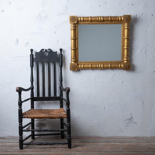 A Sheraton giltwood mirror, circa 1830. A split baluster frame with rosette corner blocks. 30 by 26 ¾ inches