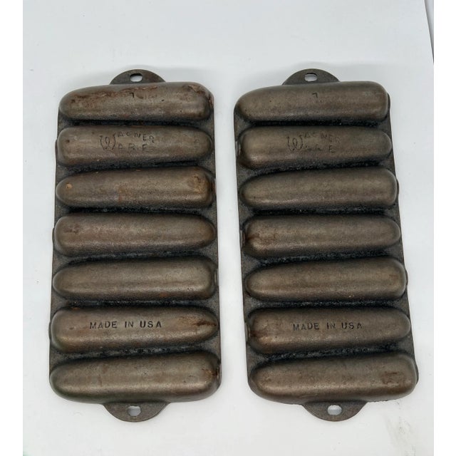 Set of two cast iron cornbread pans. They make cornbread in the shape of corn cobs. Marked Wagner Ware on the back.
