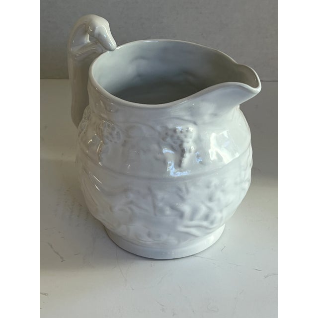 Beautiful white Loucarte Portugal Embossed Pitcher with stags, dogs and grapes and a Stag Handle. Measurement includes the...