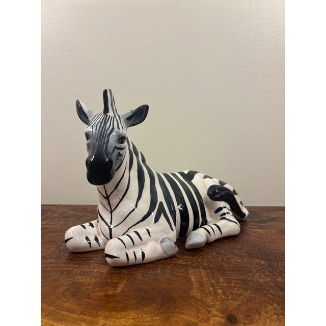 Charming 1950s Italian ceramic zebra sculpture, beautifully modeled in a relaxed reclining pose and finished with bold...