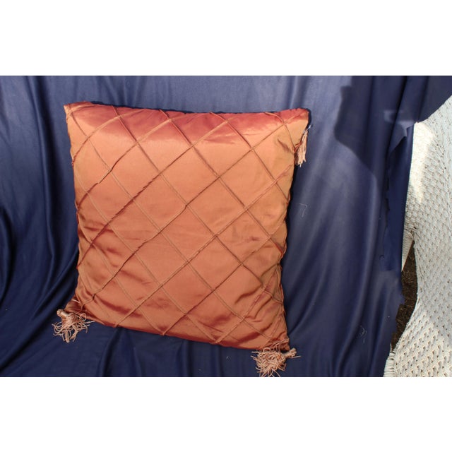 Late 20th c. down argyle pattern pillow. The piece is an burnt orange/copper color.