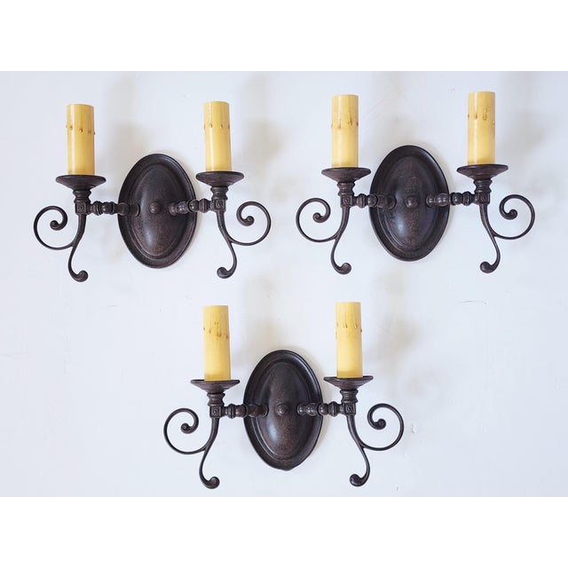 Set of 3 bronze rust finish double arms wall sconces designed by Steven Handelman Studios. The wall sconces named "...