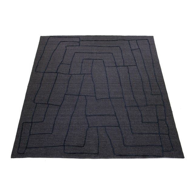 This exquisitely designed modern wool rug is bound to captivate attention. Its sophisticated gray background provides the...