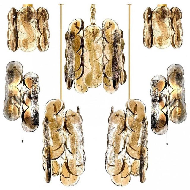 A set of gorgeous hand blown murano glass light fixtures by kalmar, 1970s. High quality smoked swirl ice glass, clear...