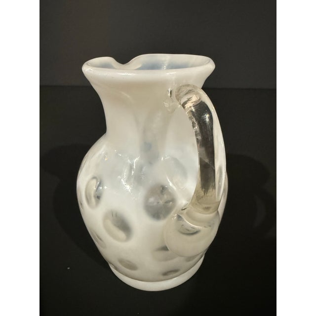 This vintage hand-blown glass pitcher is crafted in luminous opaline glass and stands approximately 4.5 inches high. The...