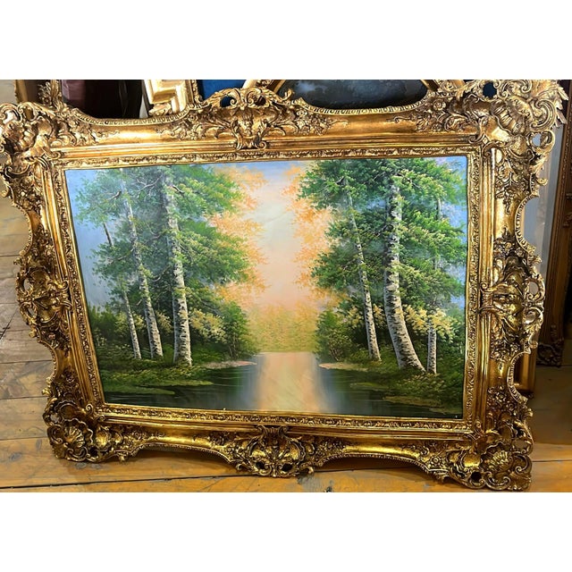 Bring the beauty of nature into your home with this grand landscape wall art, featuring a serene woodland scene framed by...