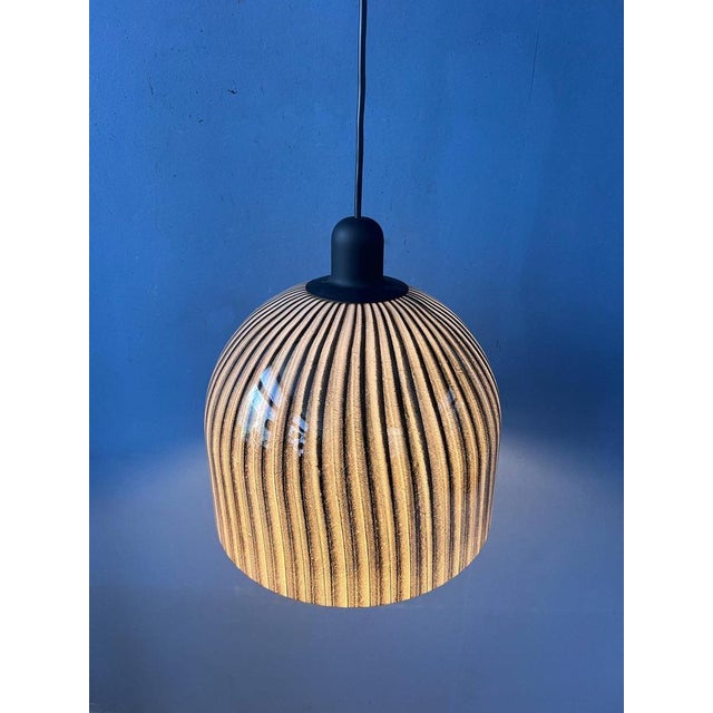 Unique mid-century pendant light by Peill & Putzler. The thick glass shade features a beautiful swirl pattern that creates...