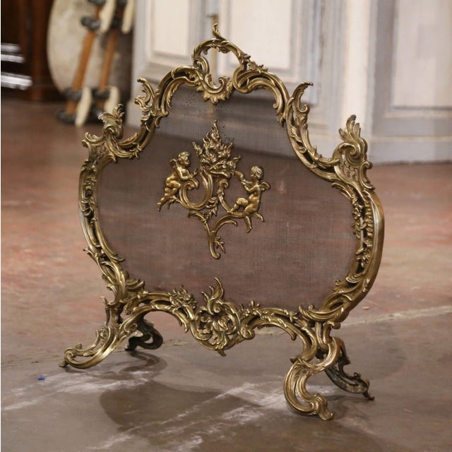 Decorate your fireplace with this elegant antique screen. Crafted in France circa 1870 and built of bronze, the shaped...